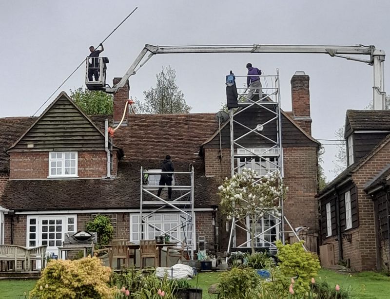 The Moss Cleaners using cherry picker and scaffolding to clean roof safely and professionally in Bulkington, Warwickshire